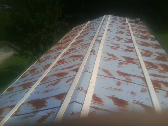 Rusted metal roof panels with new wood purlins before replacement — Storm Damage Roof Repair in Valyermo by Roofing Brothers