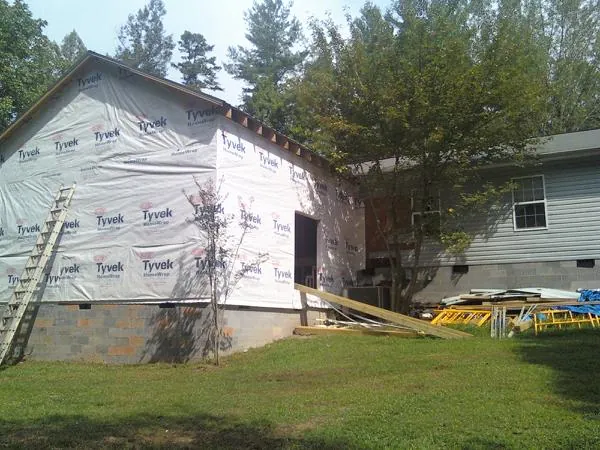 Tyvek wrapped gable on a new room addition beside an existing home in Valyermo